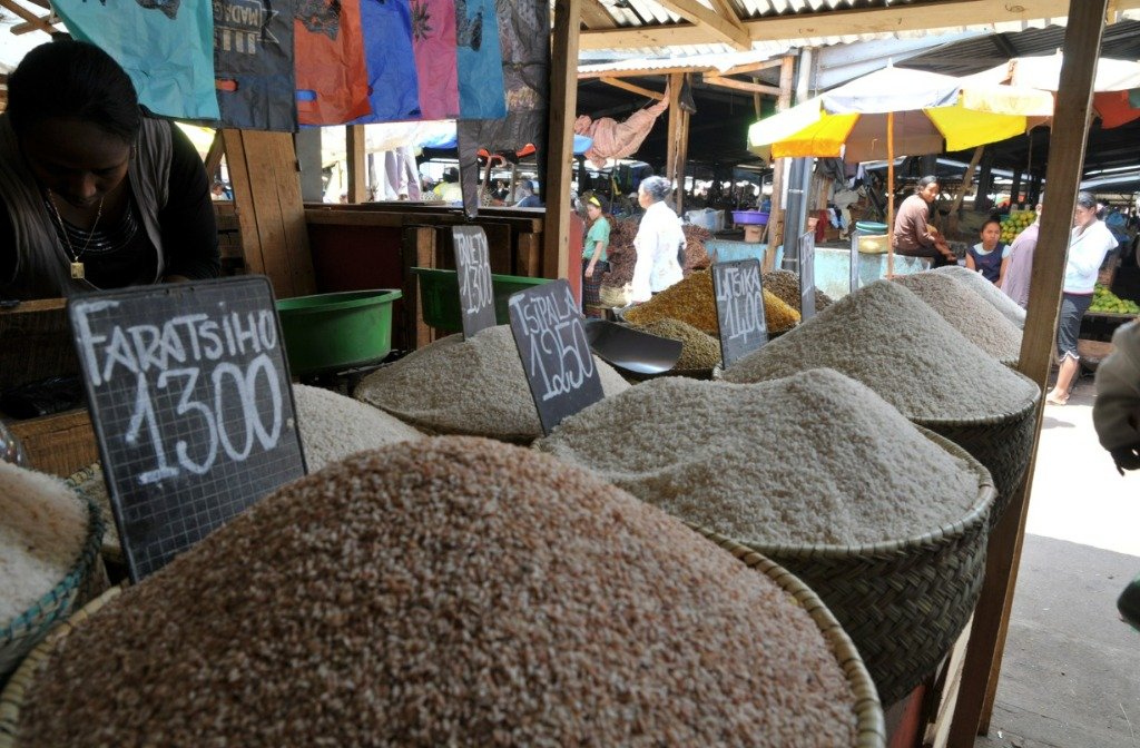 Local Malagasy rice market showing baskets of harvested varieties